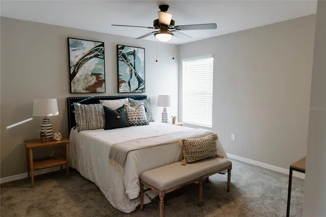 a bedroom with a bed a stove and a window