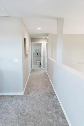 a view of hallway with closet and wooden floor