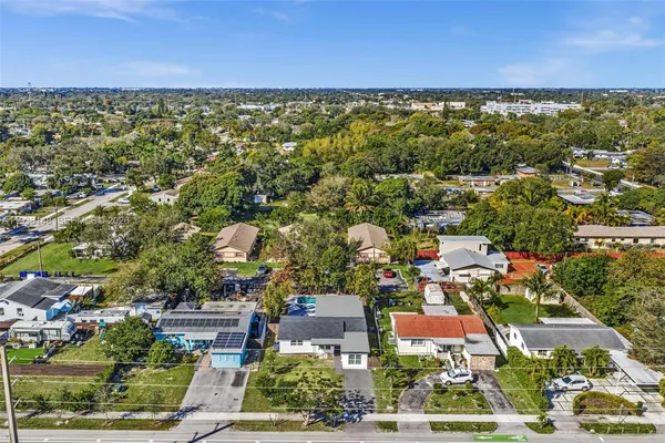 an aerial view of residential houses with outdoor space and street view