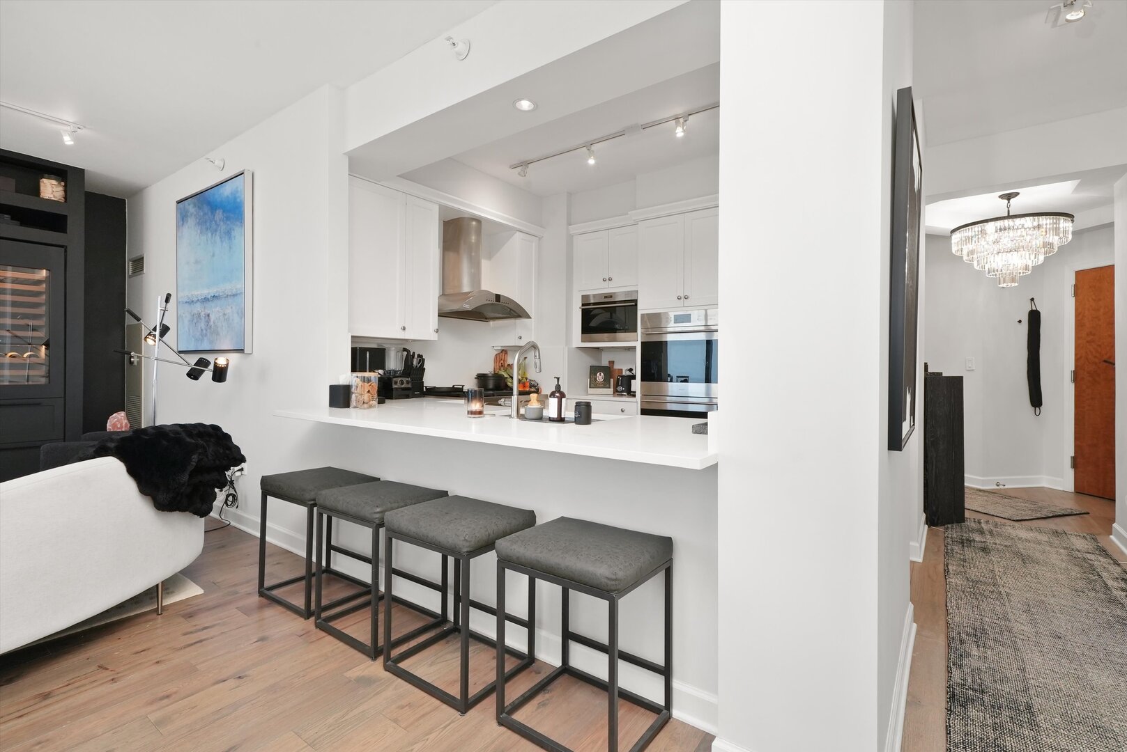 1201 South Prairie Avenue, Unit 2403 Chicago, IL 60605 - Photo 15 of 52 a kitchen with stainless steel appliances granite countertop a table chairs and a refrigerator
