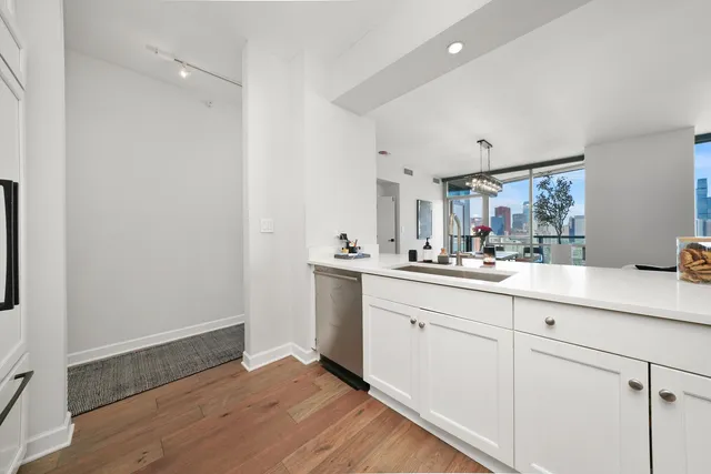 a spacious bathroom with double vanity a mirror a bathtub and a sink