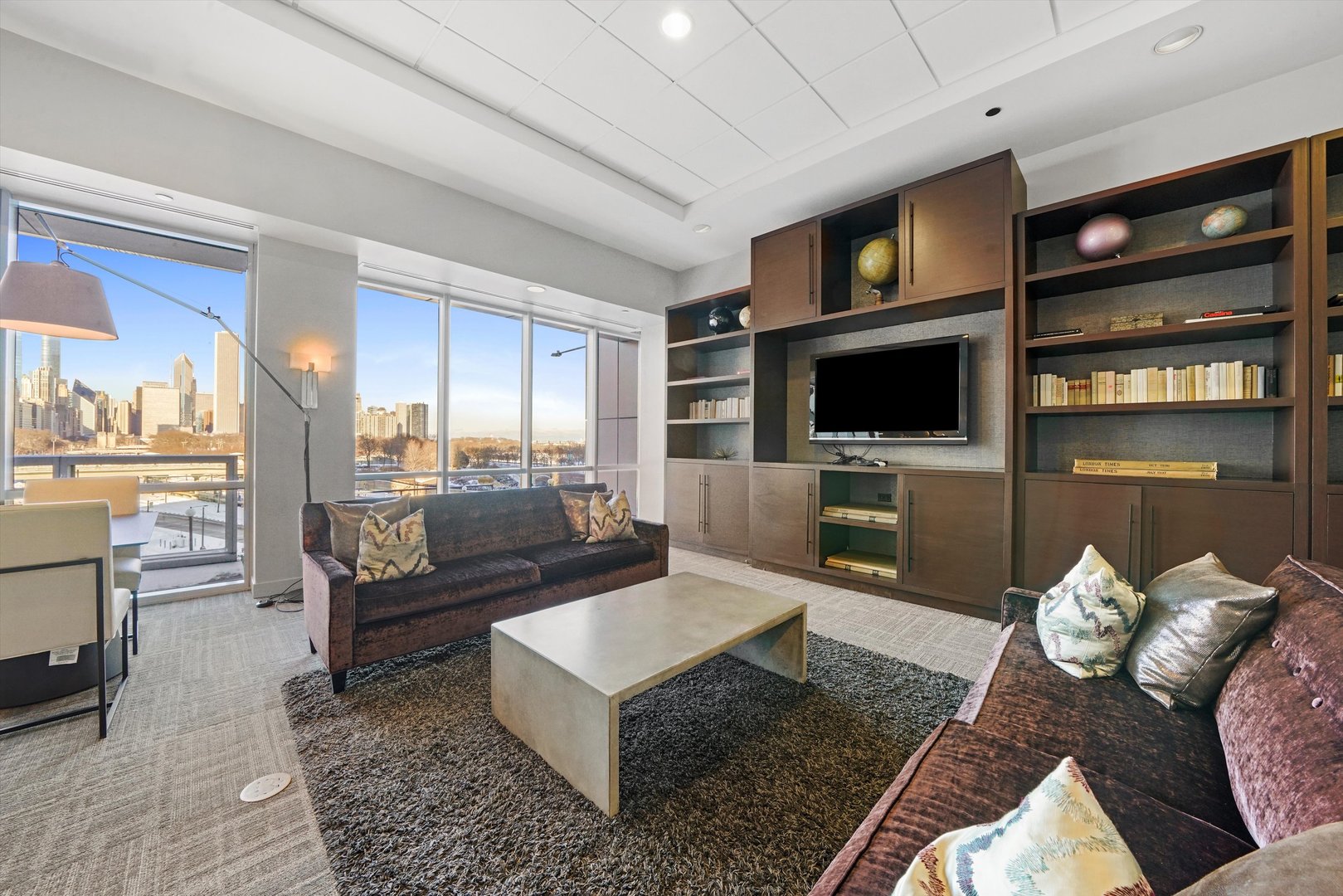 1201 South Prairie Avenue, Unit 2403 Chicago, IL 60605 - Photo 44 of 52 a living room with furniture a flat screen tv and kitchen view