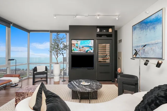 a living room with furniture a large window and a table