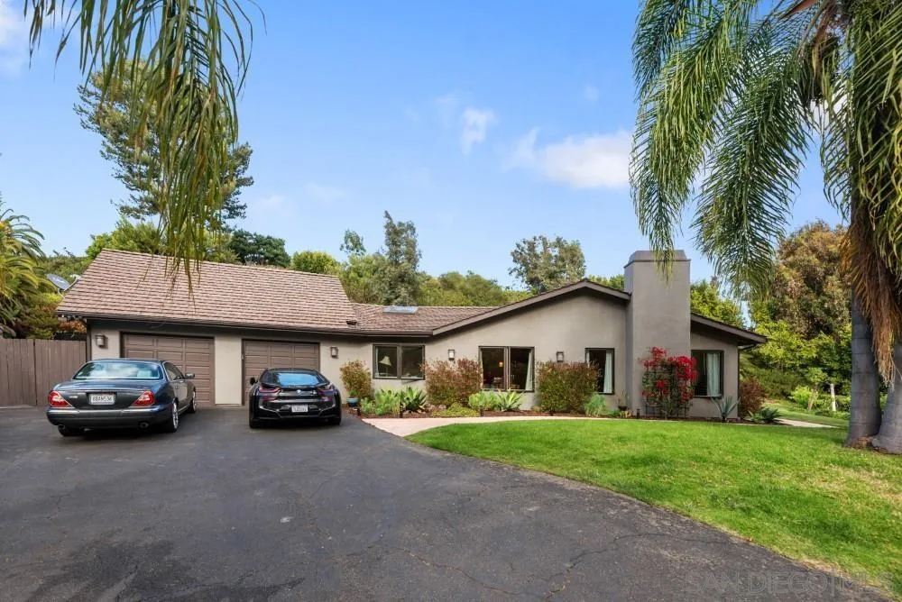 16919 Reposa Alta Rancho Santa Fe, CA 92067 - Photo 1 of 51 a car parked in front of a house with a garden
