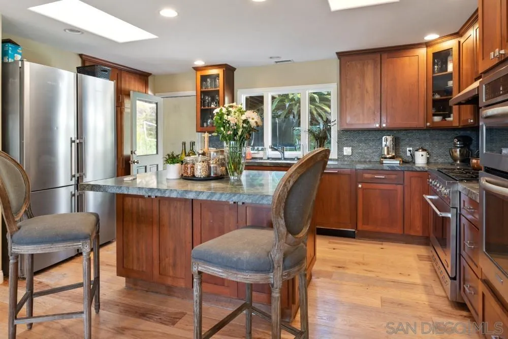 16919 Reposa Alta Rancho Santa Fe, CA 92067 - Photo 16 of 51 a dining room with furniture a window and wooden floor