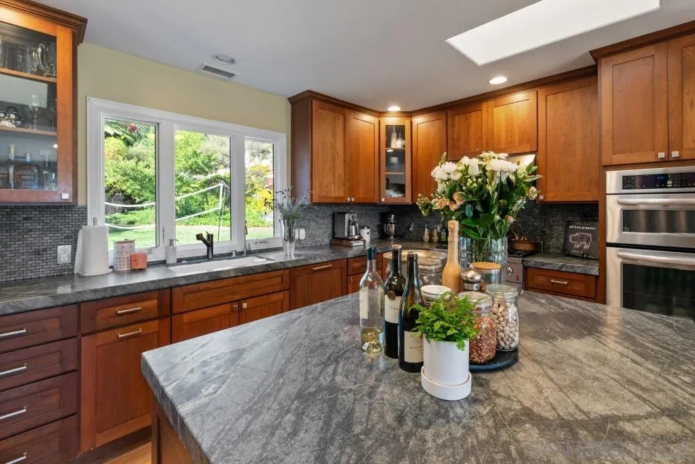 16919 Reposa Alta Rancho Santa Fe, CA 92067 - Photo 20 of 51 a kitchen with a large window in it and kitchen island
