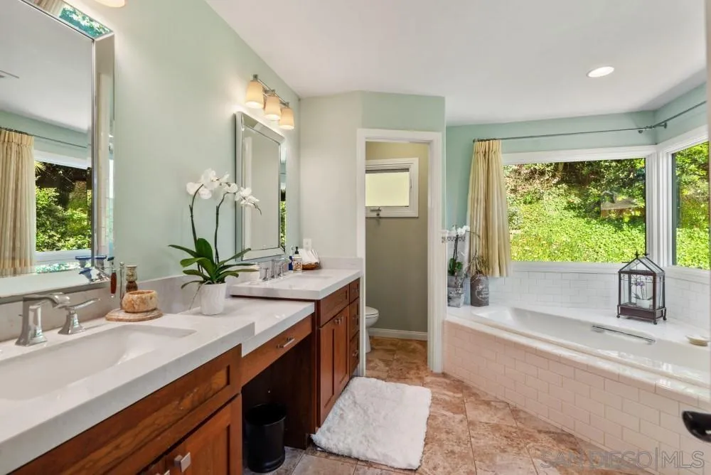 16919 Reposa Alta Rancho Santa Fe, CA 92067 - Photo 26 of 51 a spacious bathroom with a double vanity sink a mirror and a bathtub
