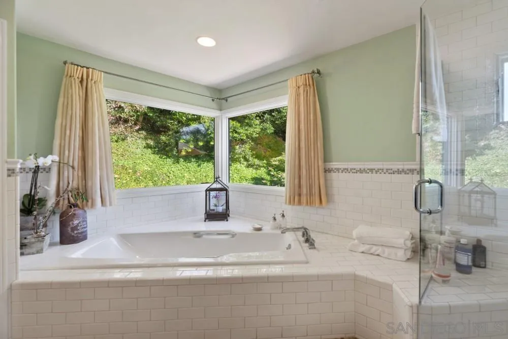 16919 Reposa Alta Rancho Santa Fe, CA 92067 - Photo 27 of 51 a bathroom with a sink and a large mirror