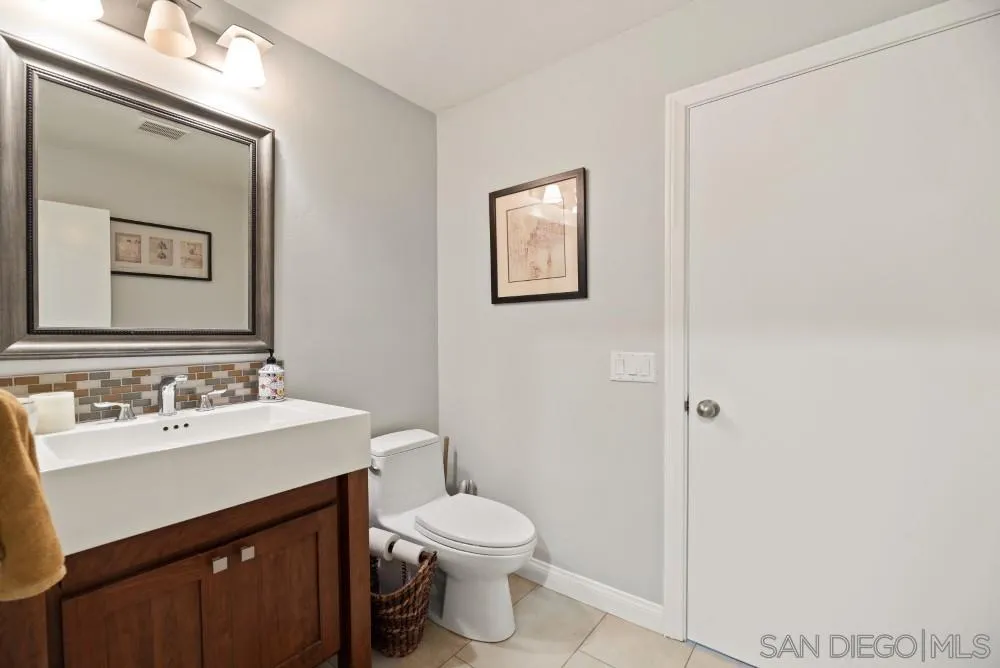 16919 Reposa Alta Rancho Santa Fe, CA 92067 - Photo 28 of 51 a bathroom with a shower sink vanity mirror and toilet