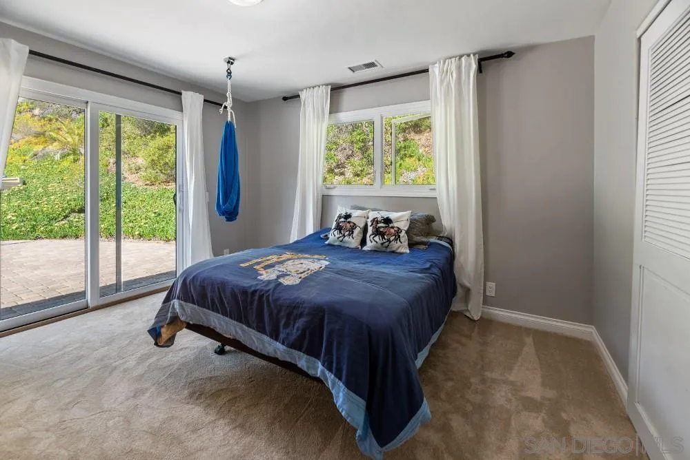 16919 Reposa Alta Rancho Santa Fe, CA 92067 - Photo 29 of 51 a bed sitting in a bedroom next to a window