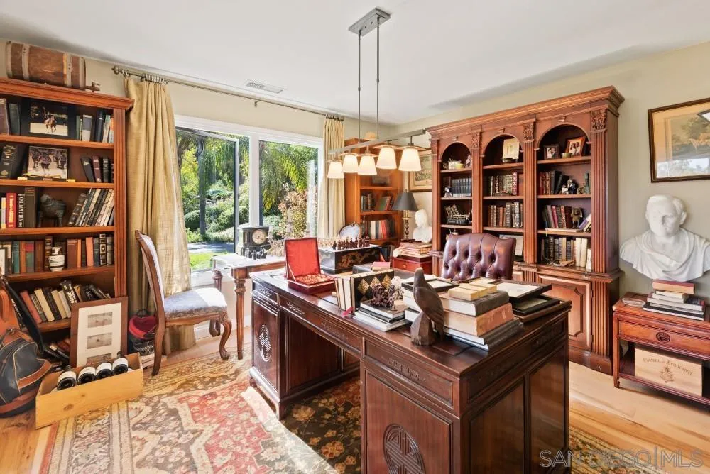 16919 Reposa Alta Rancho Santa Fe, CA 92067 - Photo 3 of 51 a view of a workspace with furniture and a bookshelf