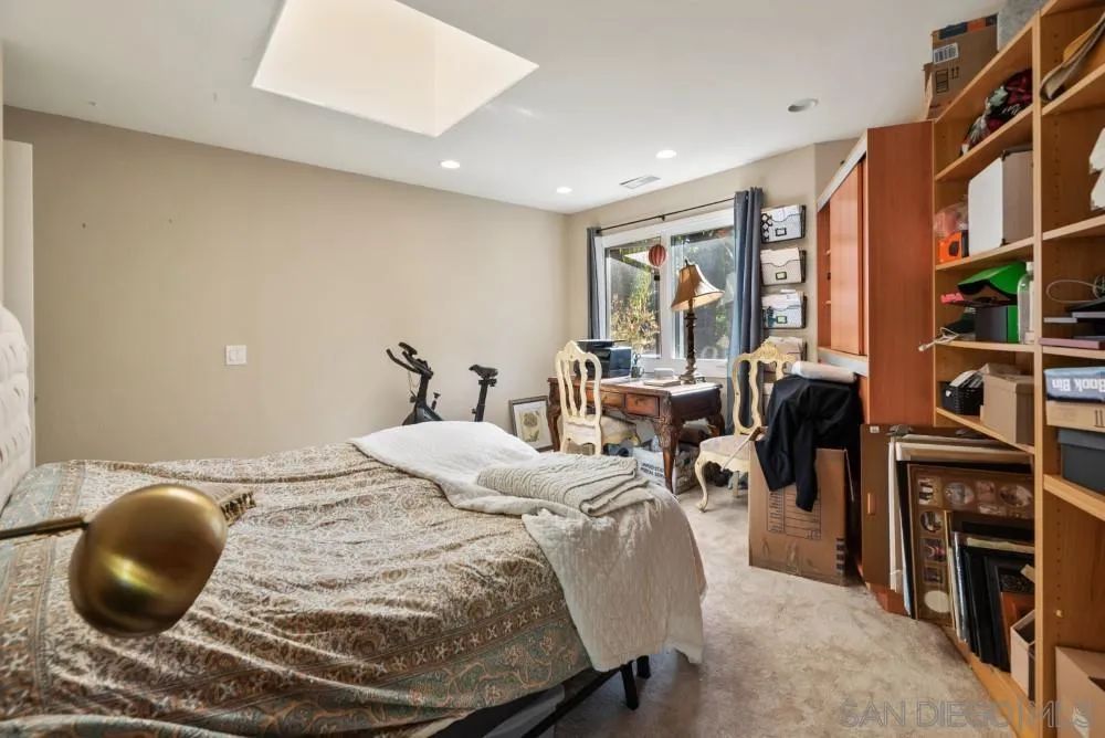 16919 Reposa Alta Rancho Santa Fe, CA 92067 - Photo 32 of 51 a bedroom with a bed a large window and book self