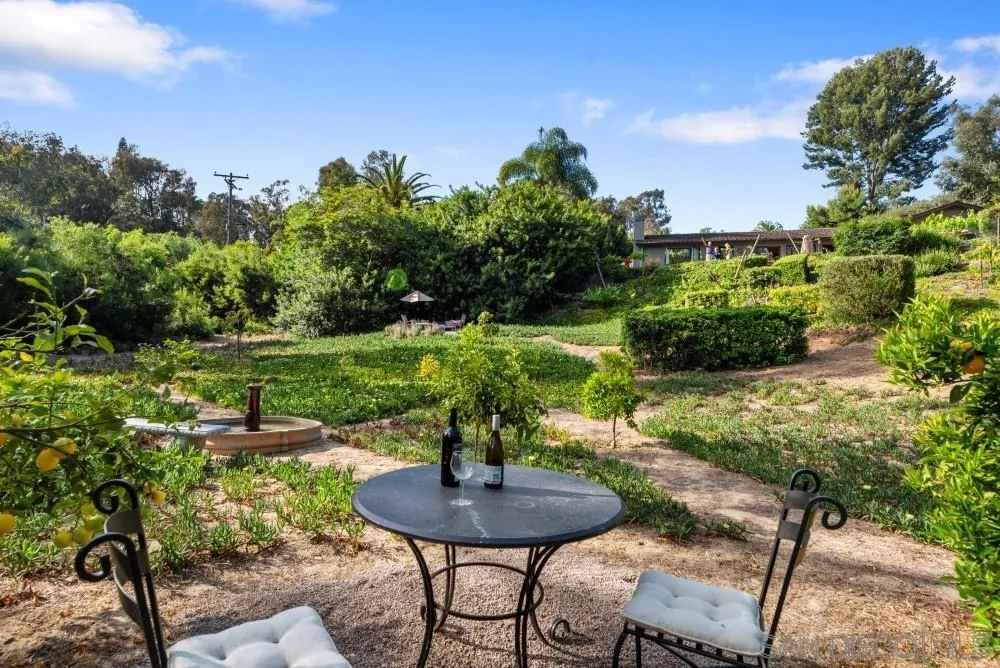 16919 Reposa Alta Rancho Santa Fe, CA 92067 - Photo 36 of 51 a backyard of a house with table and chairs