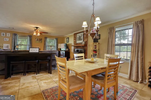 a view of a dining room with furniture and window