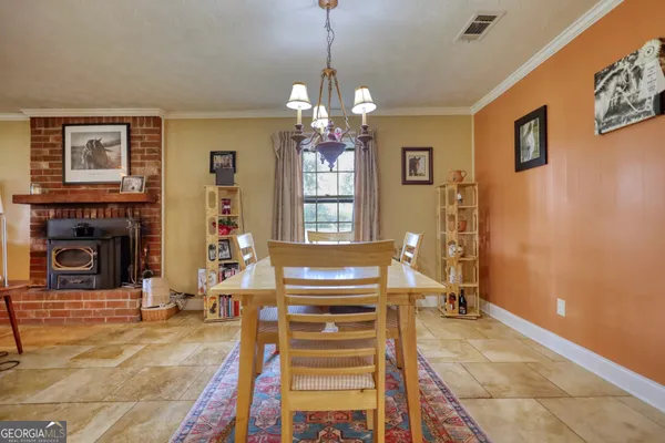 a living room with furniture a fireplace and a chandelier
