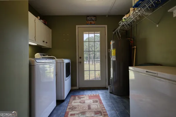 a utility room with closet dryer and washer