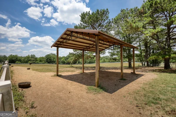 a backyard of a house with table and chairs