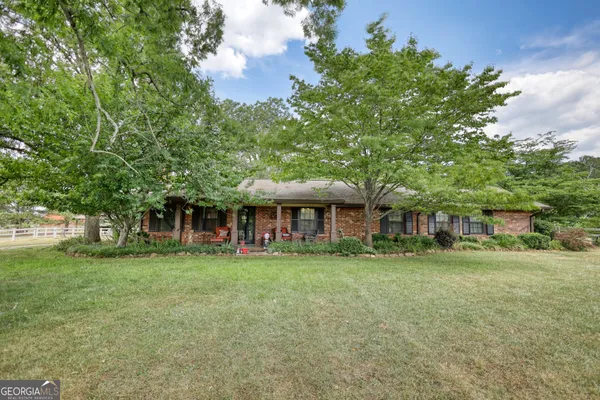 front view of a brick house with a big yard