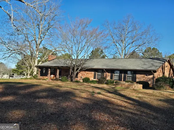 a front view of a building with trees