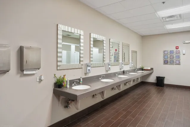 a bathroom with double vanity sinks and a mirror