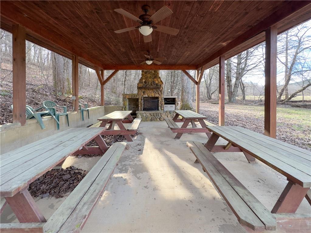 357 Mystic Lane Blue Ridge, GA 30513 - Photo 38 of 58 a view of a patio with table and chairs potted plants and floor to ceiling window