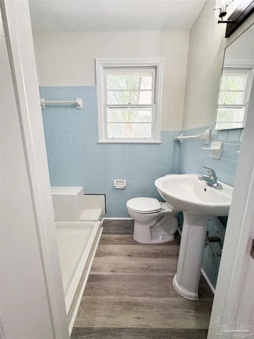 a bathroom with a sink toilet and a mirror