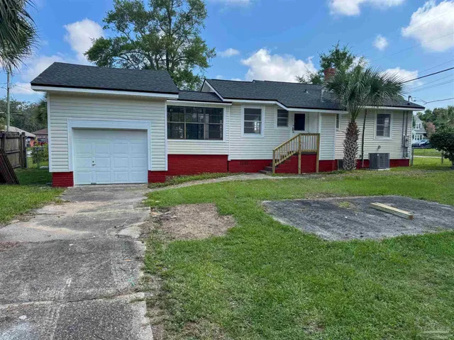 a front view of house with yard and green space