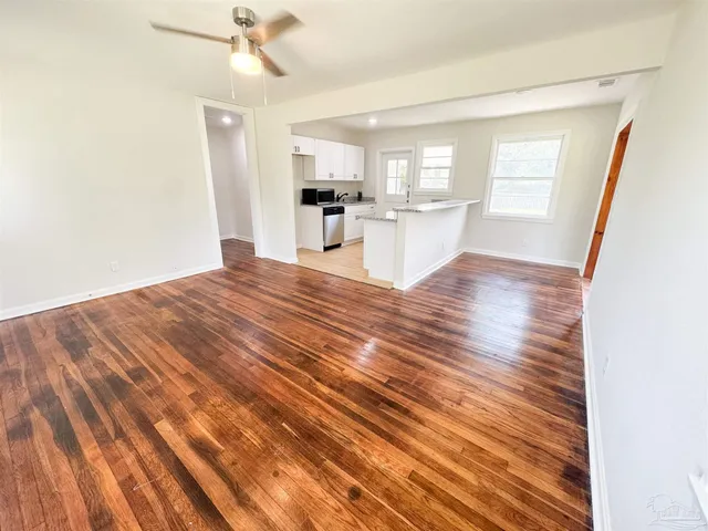 a view of a kitchen with wooden floor and a kitchen view