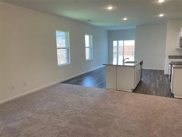 a kitchen with kitchen island a sink stove and microwave
