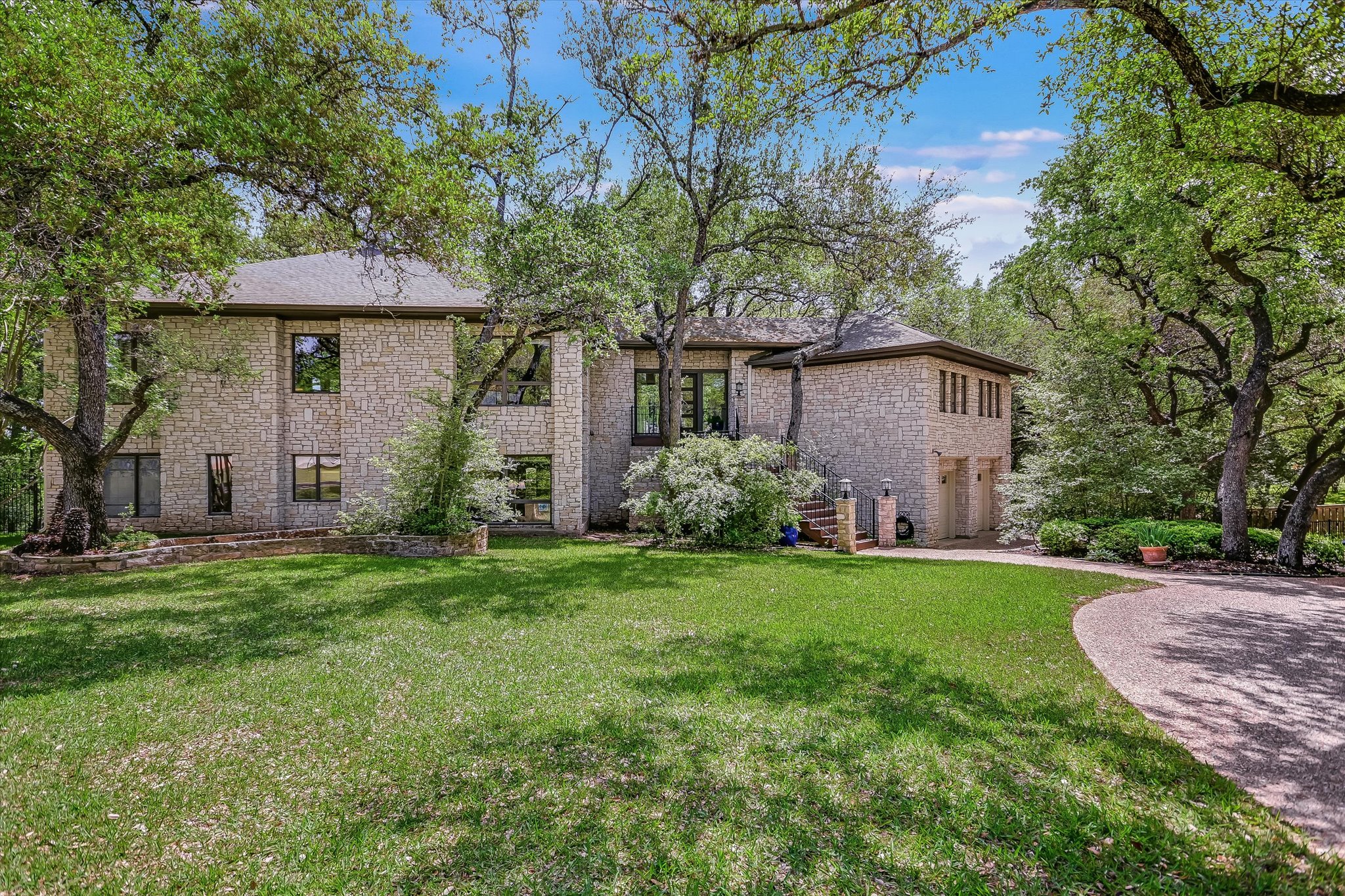 3901 Prentice Lane Austin, TX 78746 - Photo 31 of 40 The home's positioning offers a unique treehouse-like presence nestled among the surrounding greenery.