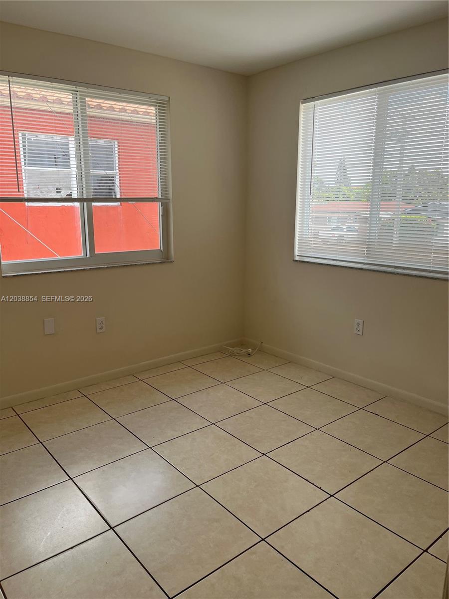 1419 Southwest 22nd Avenue Miami, FL 33145 - Photo 12 of 20 a view of an empty room with a window