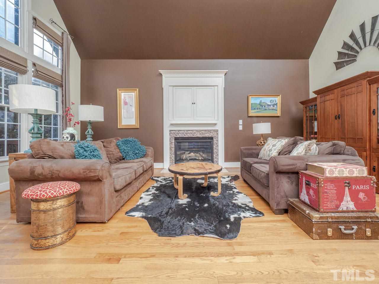 4604 Whitmire Place Raleigh, NC 27612 - Photo 11 of 25 a living room with furniture and a fireplace