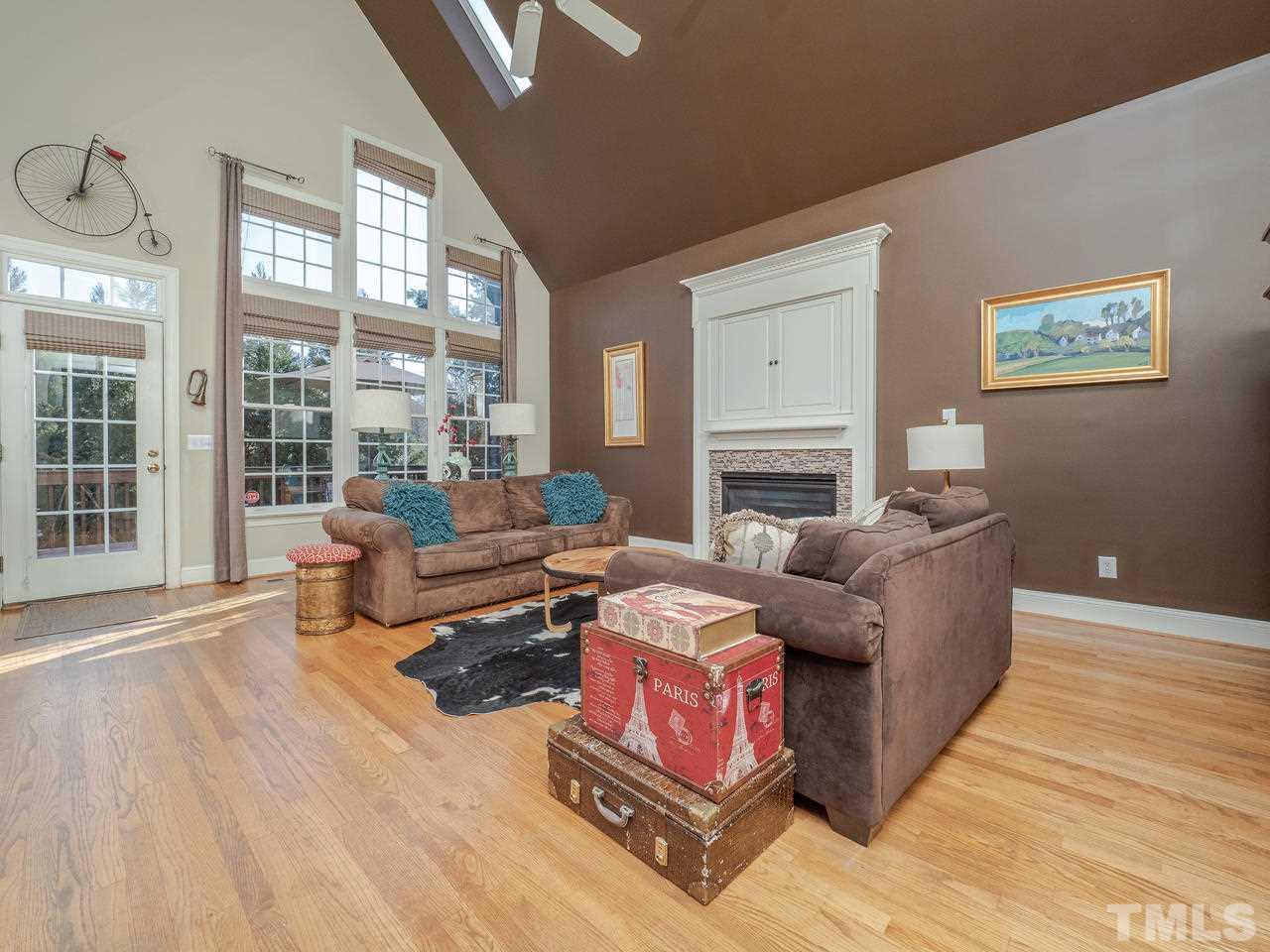 4604 Whitmire Place Raleigh, NC 27612 - Photo 12 of 25 a living room with furniture and a fireplace