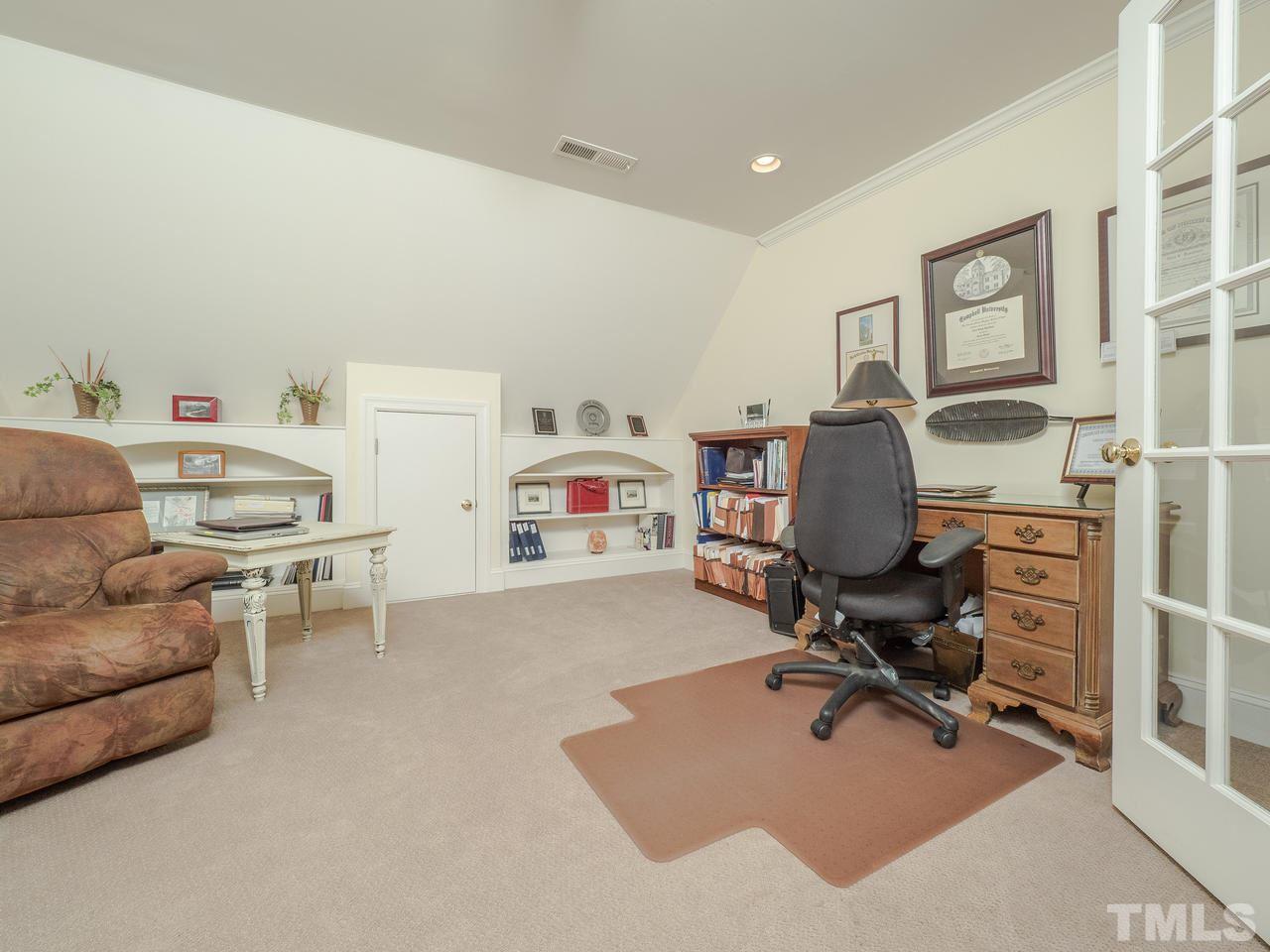 4604 Whitmire Place Raleigh, NC 27612 - Photo 17 of 25 a view of a workspace with furniture and a livingroom