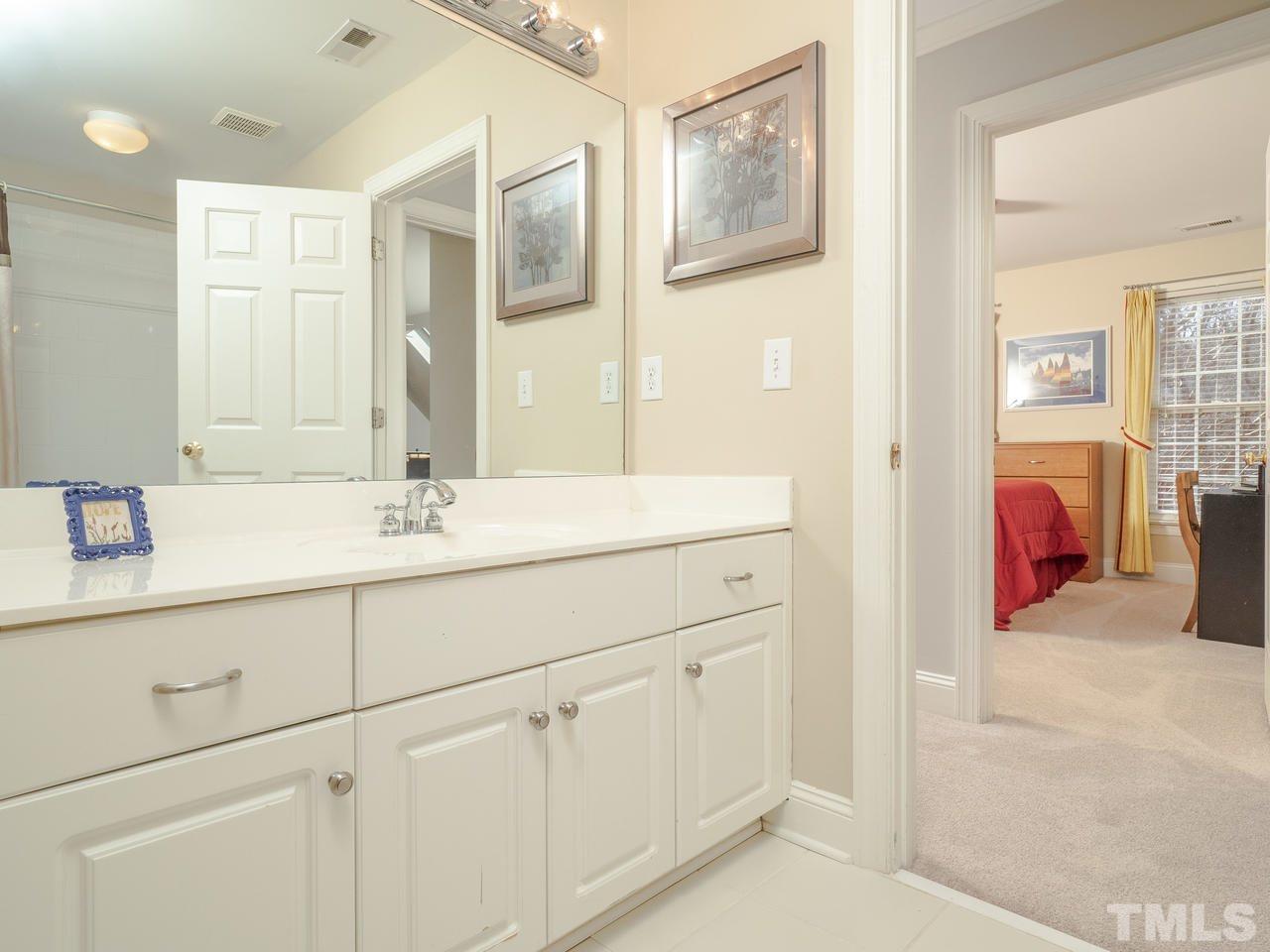 4604 Whitmire Place Raleigh, NC 27612 - Photo 19 of 25 a bathroom with a sink and a mirror