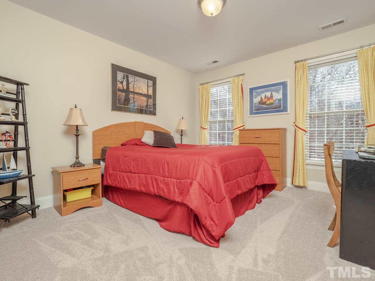 4604 Whitmire Place Raleigh, NC 27612 - Photo 20 of 25 a bedroom with a bed furniture and a window