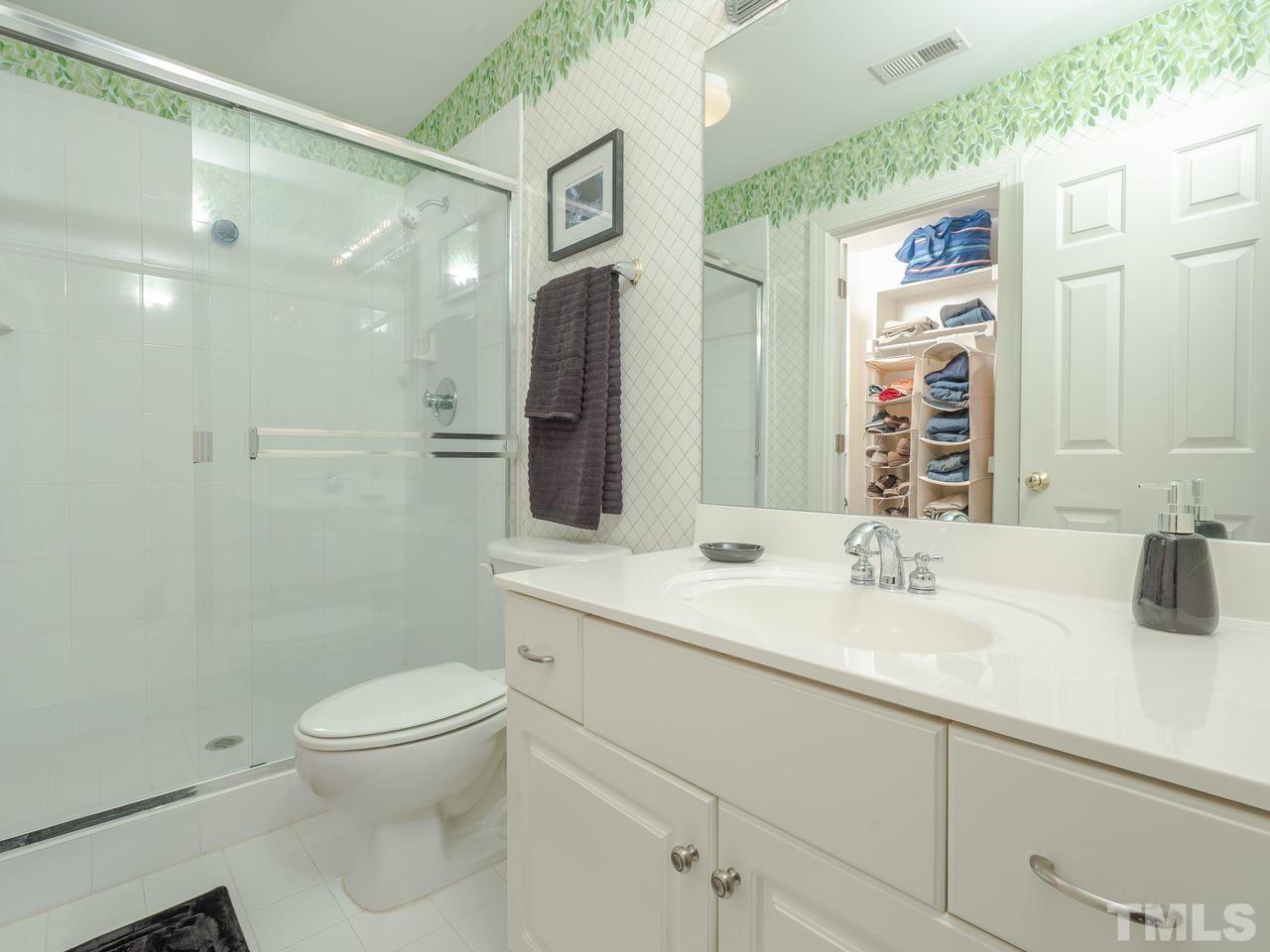4604 Whitmire Place Raleigh, NC 27612 - Photo 23 of 25 a bathroom with a sink a toilet and shower