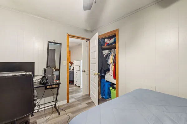 a bed room with a bed and a chair