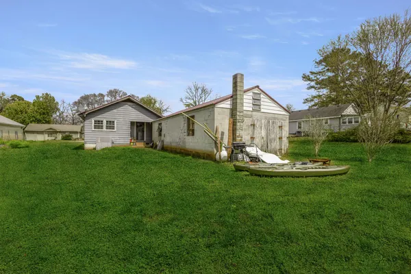 a view of a house with a yard and sitting area