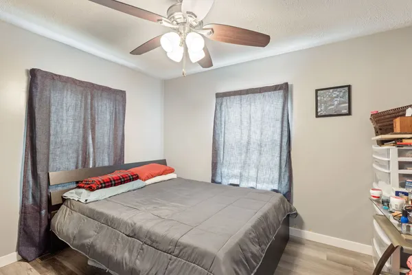 a bedroom with a bed and a chandelier