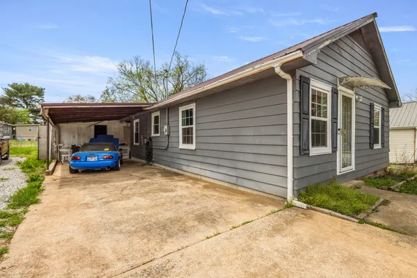 a car parked in front of white house