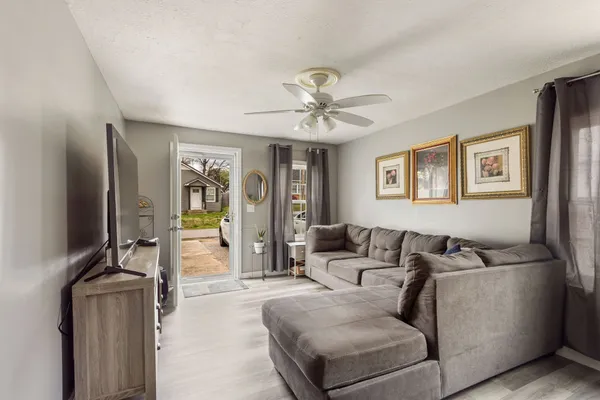 a living room with furniture and a flat screen tv