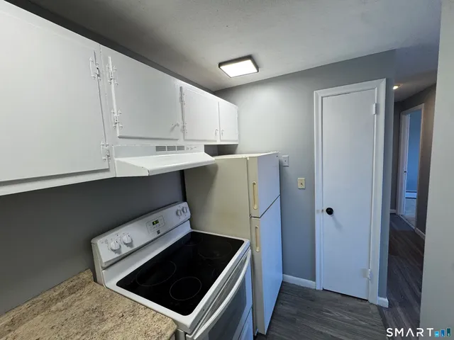 a kitchen with a stove and a refrigerator