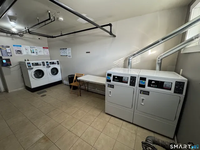 a utility room with multiple dryer and washer
