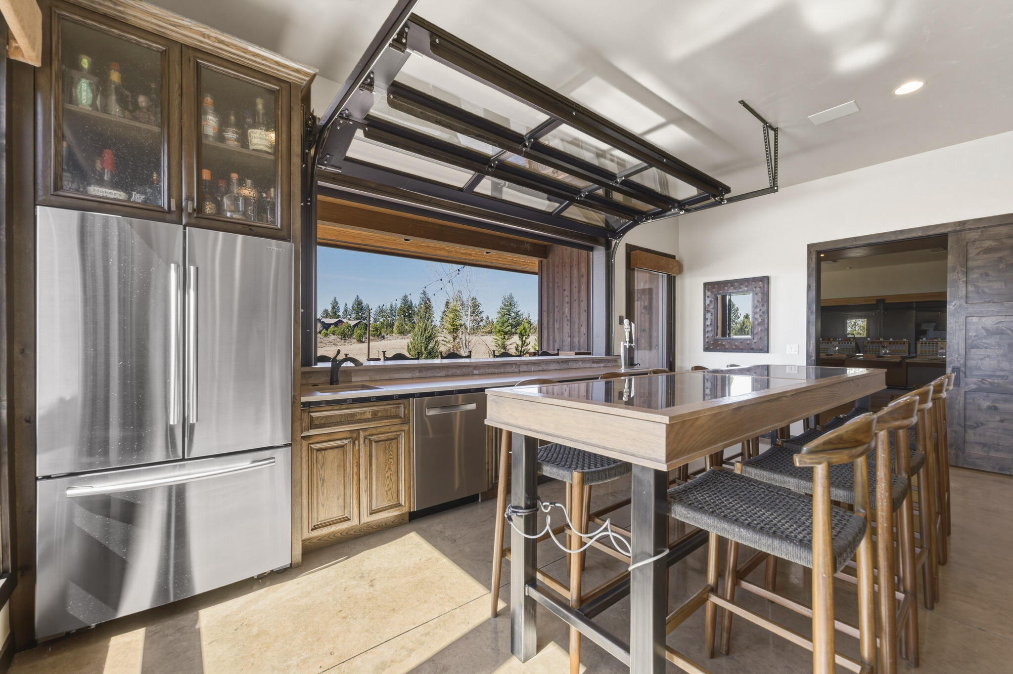 19100 Macalpine Loop Bend, OR 97702 - Photo 43 of 56 Poolhouse with Pass-through serving bar, half roll-up door (9ft wide) and wet bar