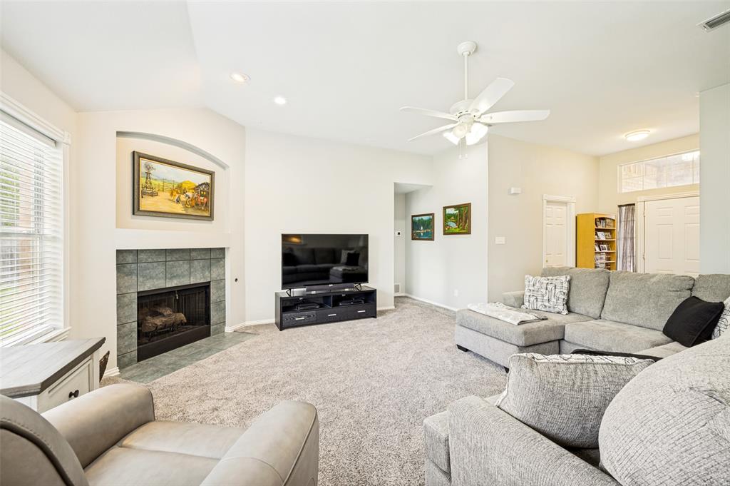 206 Ridge View Court Decatur, TX 76234 - Photo 10 of 29 a living room with furniture a fireplace and a flat screen tv