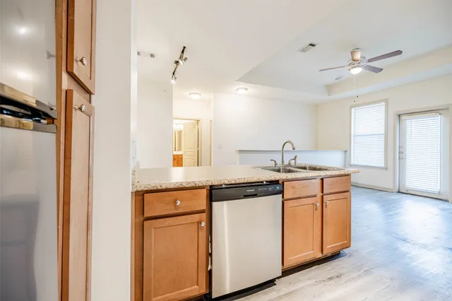 a kitchen with a stove a sink and a refrigerator