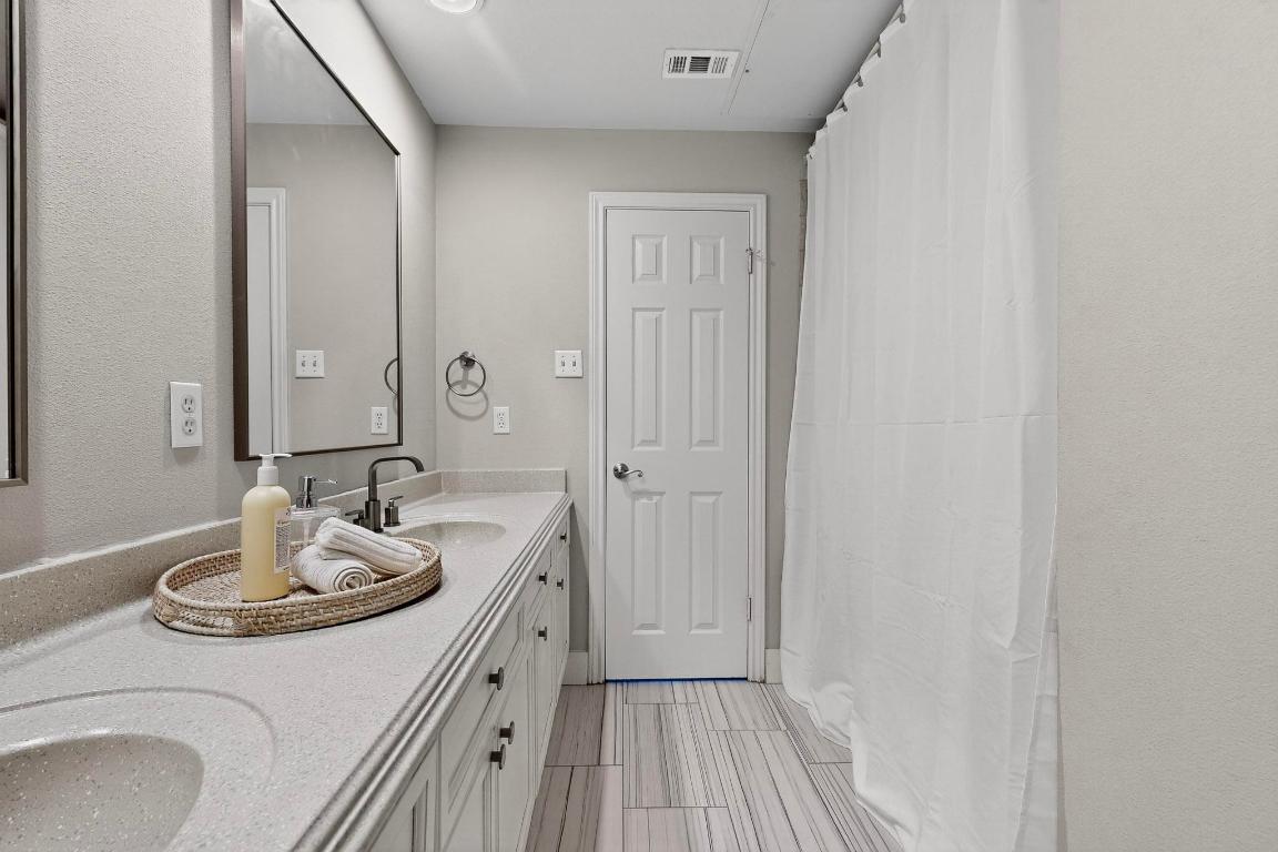 2918 Ranch Road 620 North, Unit T250 Austin, TX 78734 - Photo 17 of 22 a bathroom with a sink and a mirror