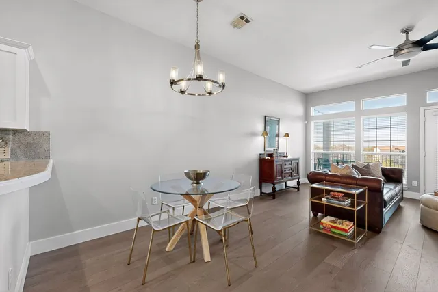 a living room with furniture a chandelier and a window