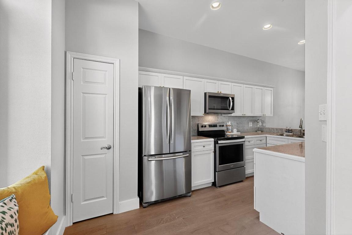 2918 Ranch Road 620 North, Unit T250 Austin, TX 78734 - Photo 7 of 22 a kitchen with a refrigerator stove and sink